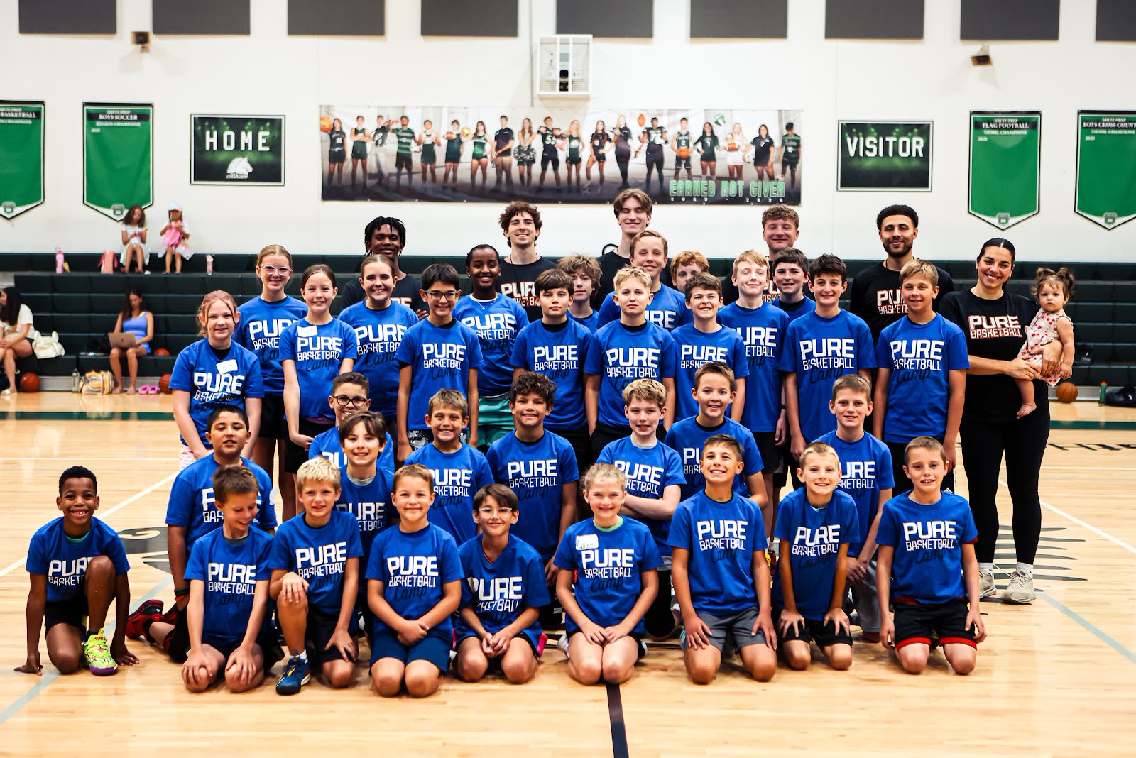 The whole Pure Basketball Camp group, campers and coaches, lined up in the gym